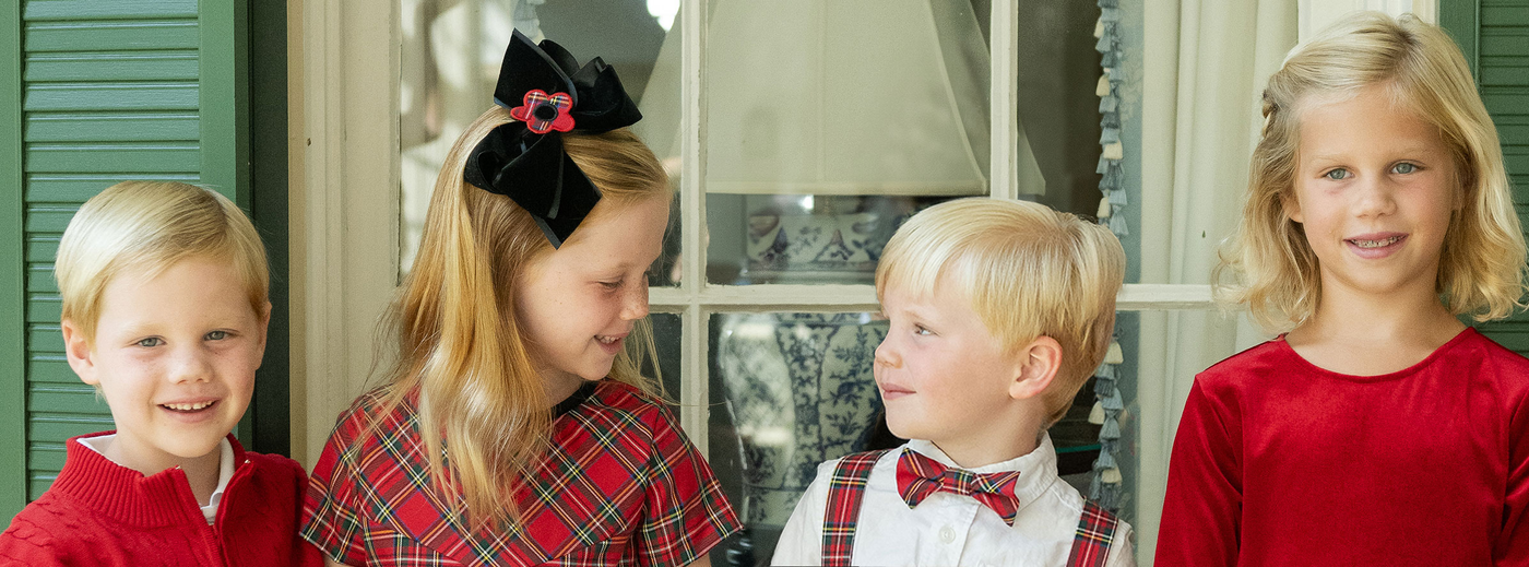 two girls with red hair bows laughing