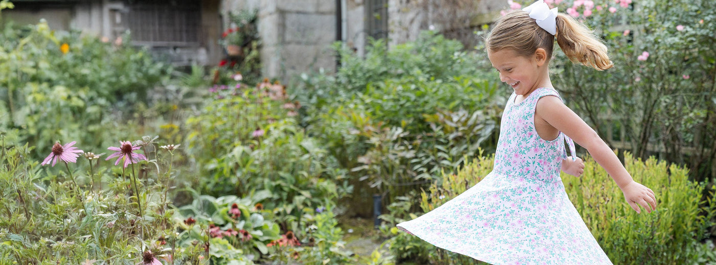 girl in garden twirling in a dress