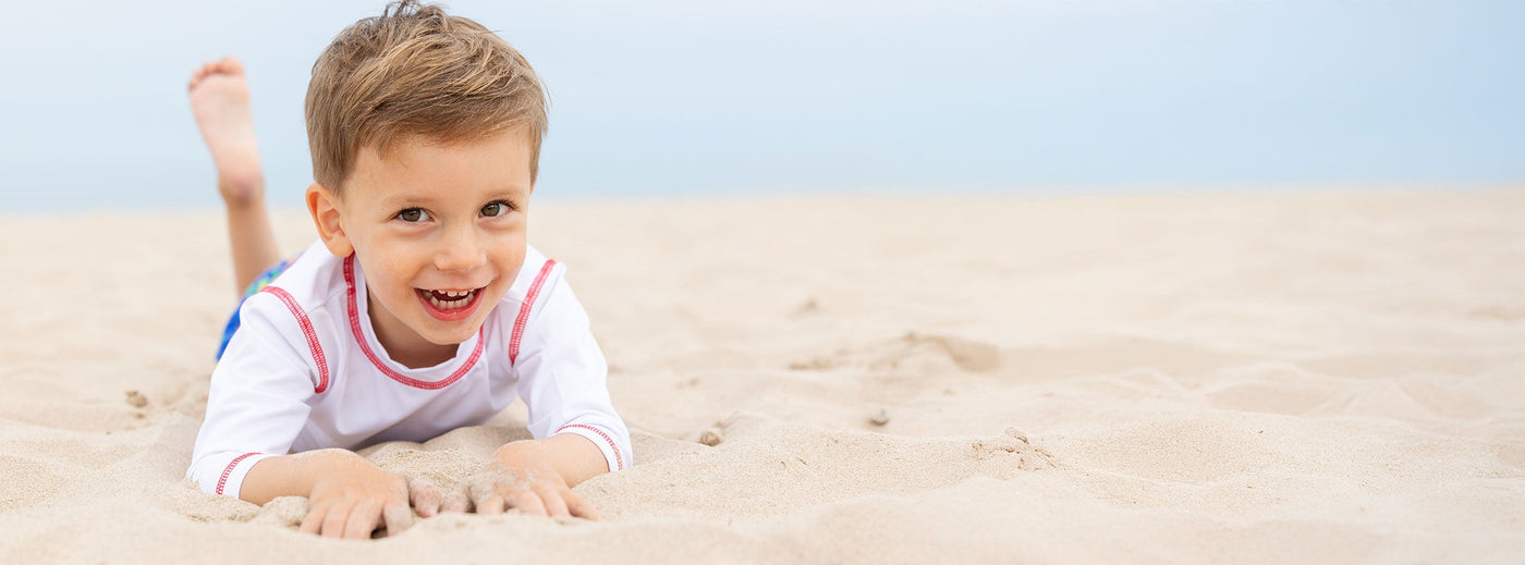 young boy in sand at beach