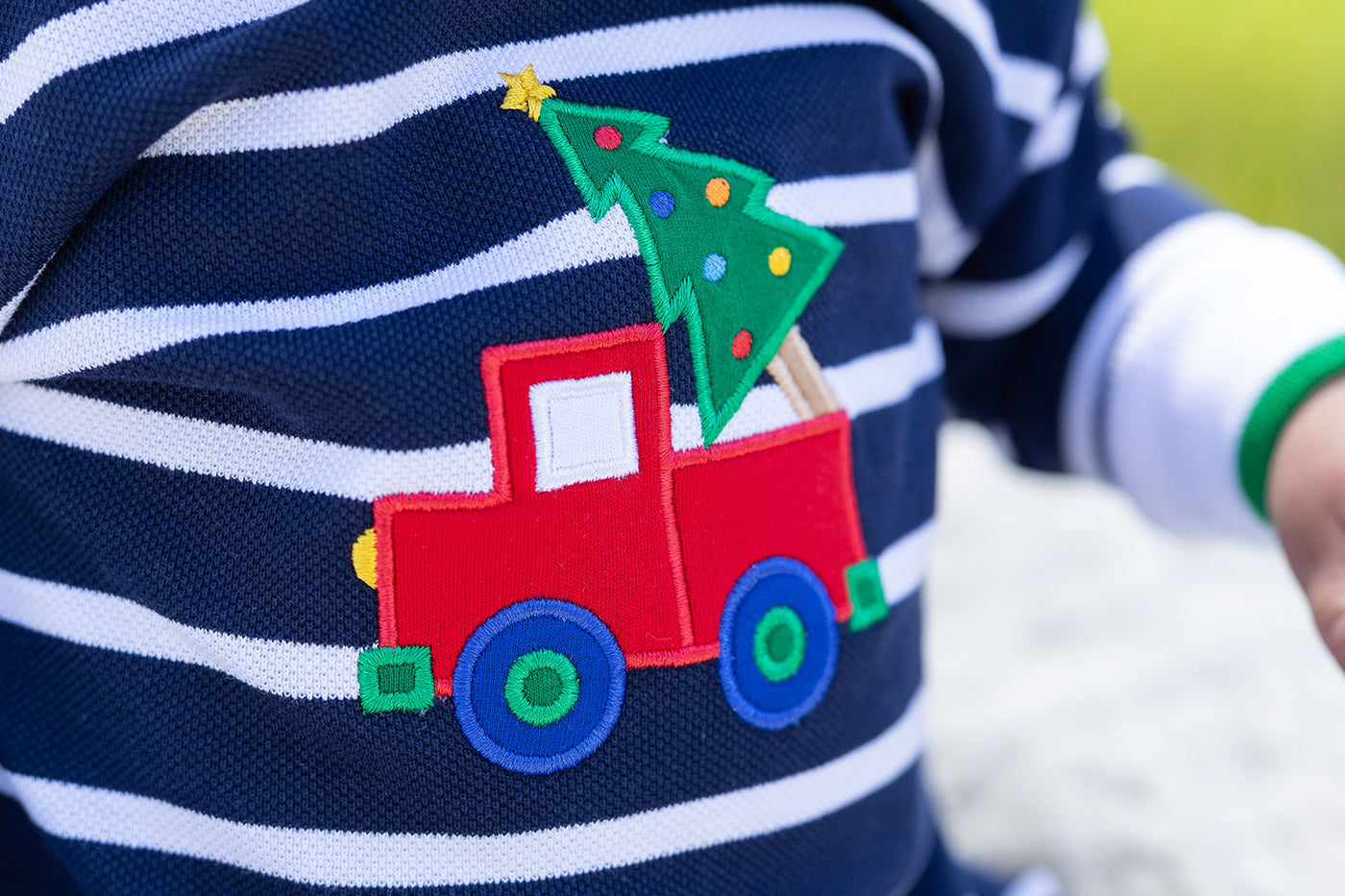 close up of a truck appliqué with a tree in the bed