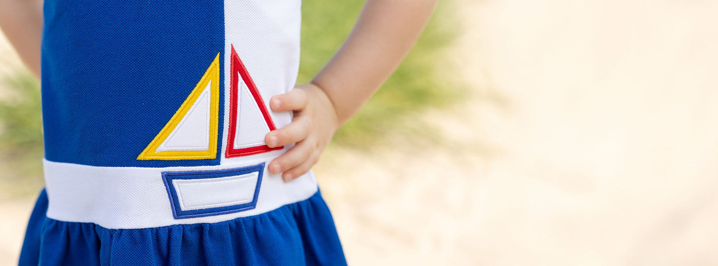 closeup of sailboat detail on blue dress