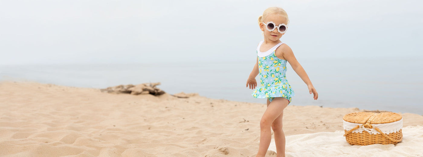 girl on beach in glasses and swimsuit